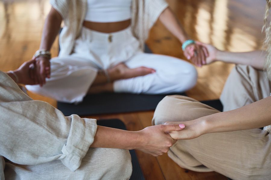 group of women holding hands on spiritual retreat