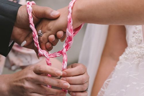 A closeup of a handfasting ceremony